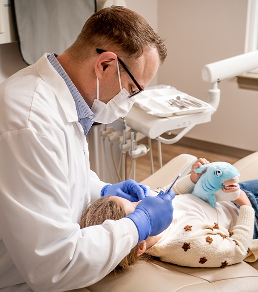 Dentist treating young dental patient
