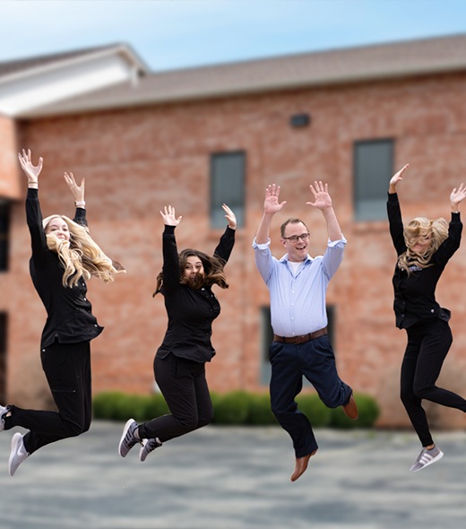 Lubbock dentist and dental team jumping in the air