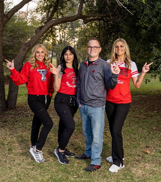 Lubbock dentist and dental team jumping in the air