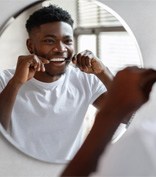 Man flossing teeth in Lubbock   