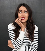 woman nervously biting her fingernails 