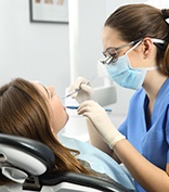 dental hygienist cleaning a patient’s teeth 