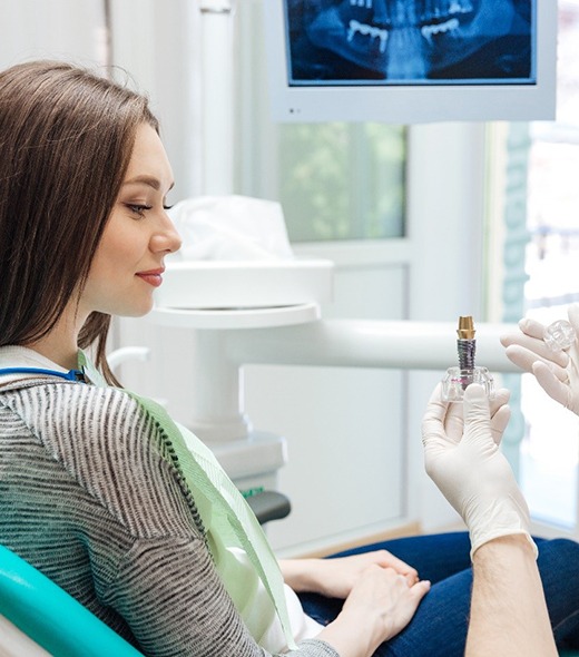 Implant dentist in Lubbock showing patient dental implant