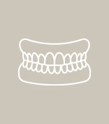 Woman looking at beautiful smile after four step dental implant process