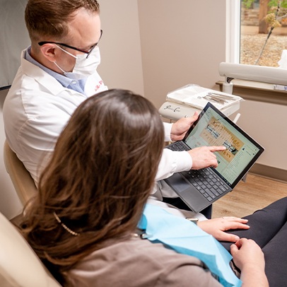 Doctor Shivley and patient reviewing dental care plan on computer screen