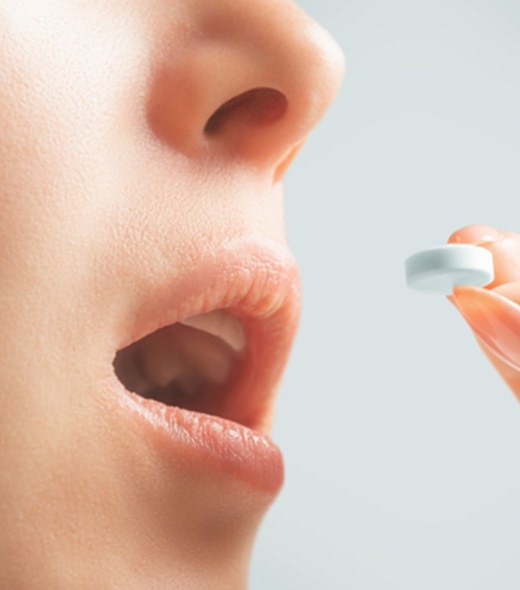 a person taking a pill for oral conscious sedation