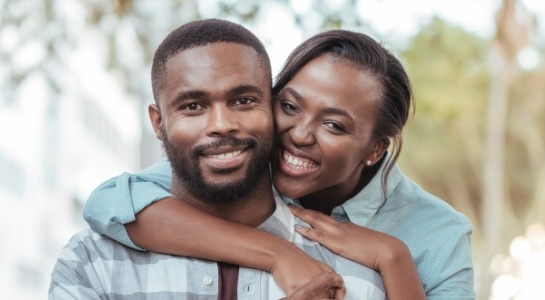 Man and woman smiling after preventive dentistry visit