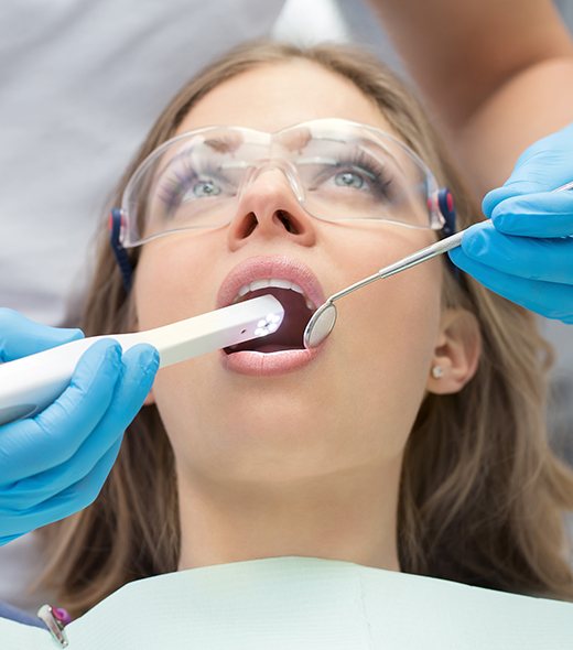 Dentist using intraoral camera to capture smile images