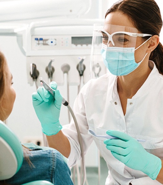 Dentist smiling at patient during dental exam