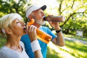 couple drinking water after exercising