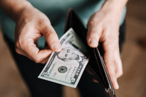 Man pulling cash out of wallet