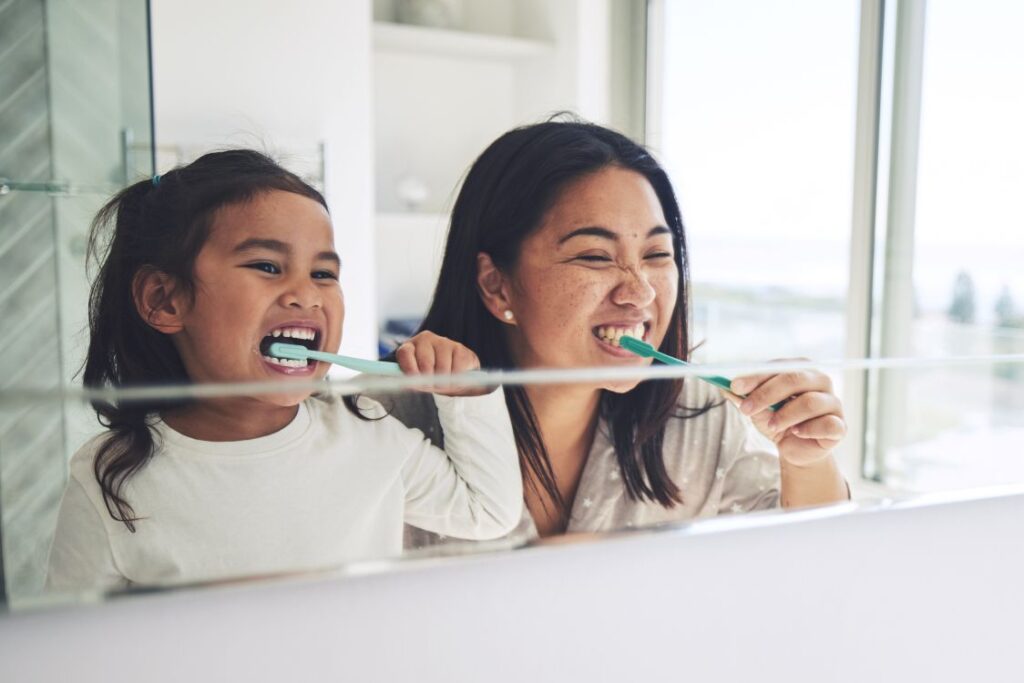 A family brushing their teeth together